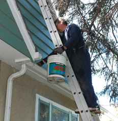 Canco Employee cleaning residential eavestrough in Edmonton and Area